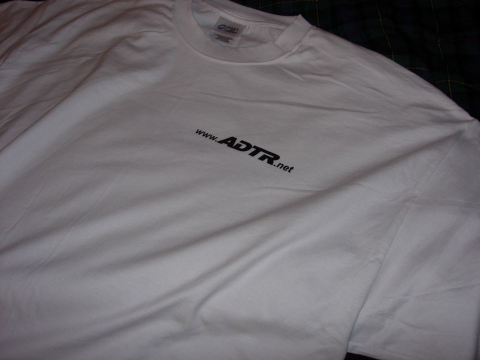 White T-shirt with small black ADTR.net chest logo on plaid