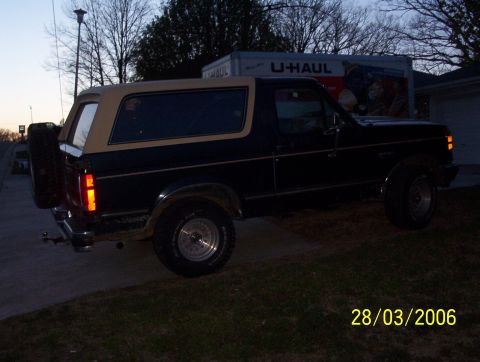 1991 Ford Bronco - This 1991 Ford Bronco is seen from the rear quarter angle, a two-tone paint scheme and a spare tire mounted on the tailgate.