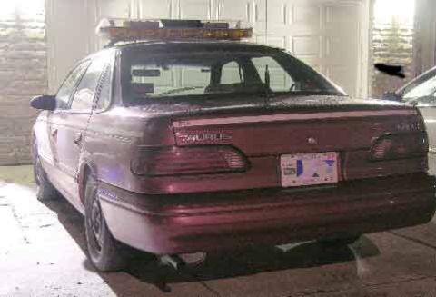 1998 Ford Crown Victoria - This vehicle is a Ford Taurus, not a 1998 Ford Crown Victoria, and has a light bar mounted on its roof.