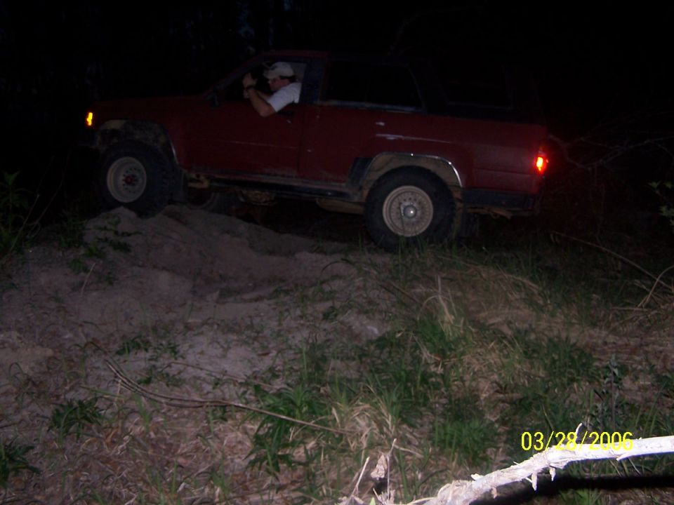 1984 Toyota 4Runner driving on a dirt hill at night