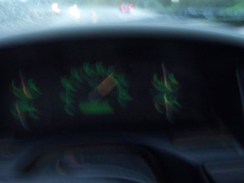 1994 Ford F-150 - Interior view of blurred dashboard gauges, showing green illumination.