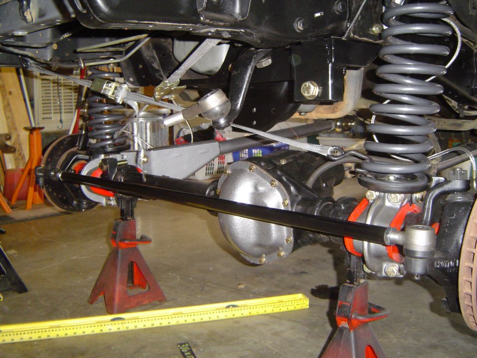 Ford solid front axle, coil springs and differential on jack stands