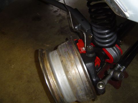 1989 Ford Bronco - The image shows a close-up view of a vehicle's suspension system, focusing on the wheel assembly and brake components.