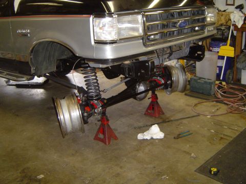1989 Ford Bronco - Front axle removed from 1989 Ford Bronco for maintenance, showing suspension components.