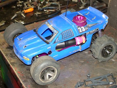 1994 Ford Bronco - This blue remote control truck has "F-350" badging and a visible nitro engine.