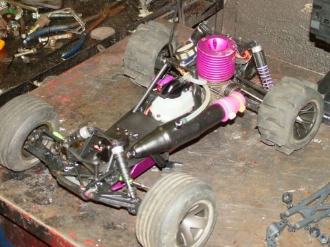 1994 Ford Bronco - A remote control car chassis is shown with its engine and suspension components visible.