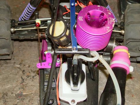 1994 Ford Bronco - The internal components of a remote control car, including its engine and fuel system, are visible.