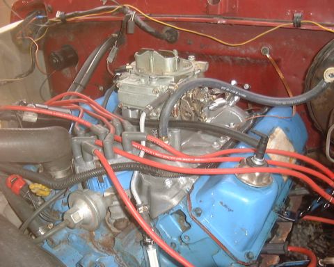 1978 Ford Bronco - The engine bay shows a V8 engine with various hoses and wiring connected.