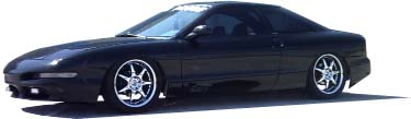 1995 Ford Probe - This black 1995 Ford Probe features custom wheels and a sporty profile.