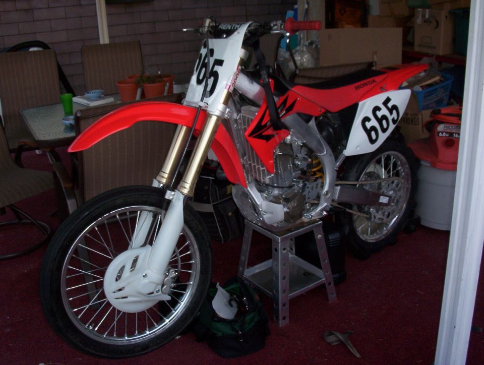 1999 Honda CR250R dirt bike with red plastics and white number plates