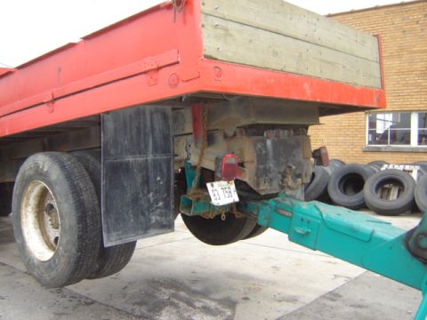1992 Ford Bronco - The rear of a red dump truck is shown, dual rear wheels and a tow hitch mechanism.