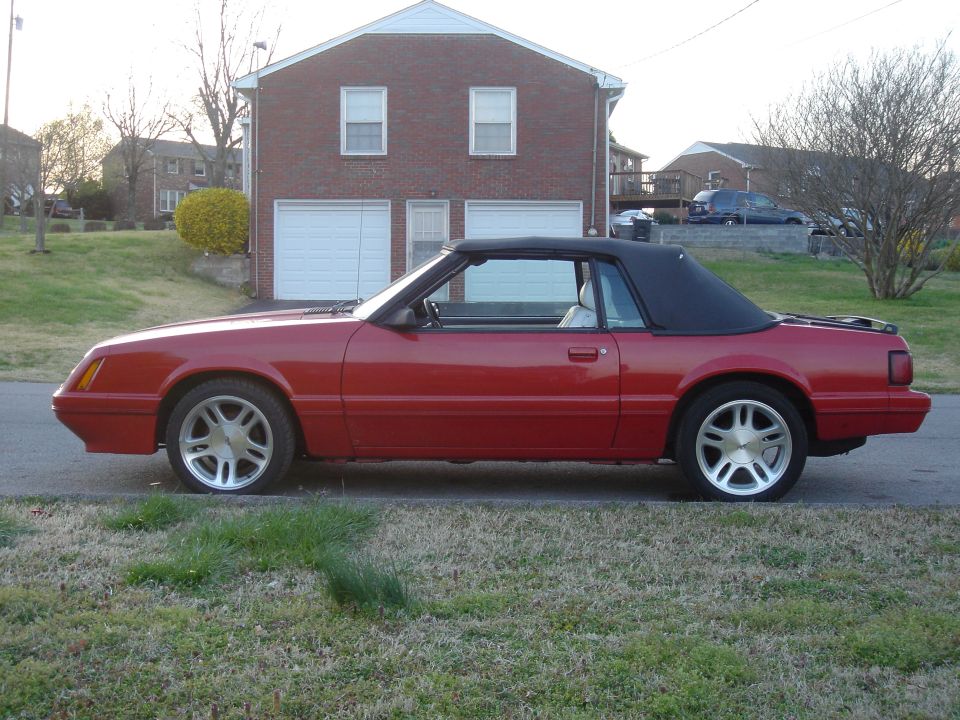 Red 1986 Ford Mustang convertible side view