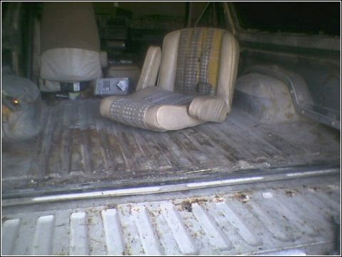1981 Ford Bronco - The cargo bed of a 1981 Ford Bronco with a seat placed inside.