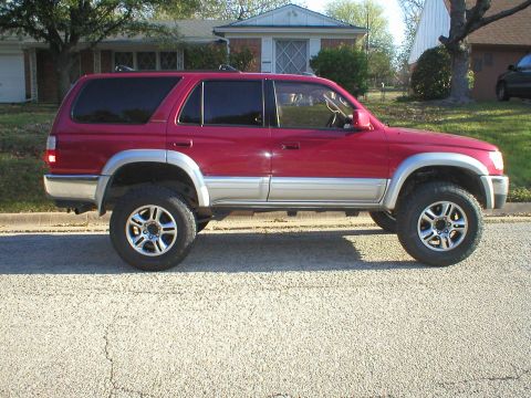 1996 Toyota 4Runner - This red 1996 Toyota 4Runner is shown from the side, a two-tone paint scheme and aftermarket wheels.