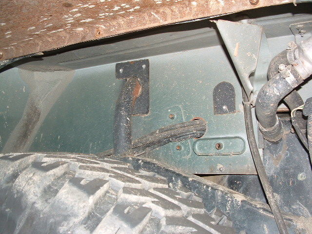 Close-up of vehicle underbody showing suspension components and tire tread