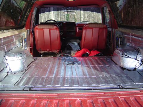 1978 Ford Bronco - The interior of a 1978 Ford Bronco shows red seats and silver sound deadening material applied to the floor and rear cargo area.