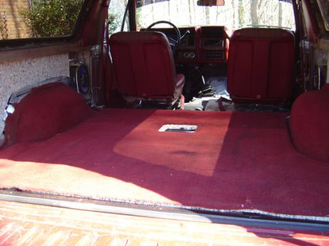 1978 Ford Bronco - Interior view of a 1978 Ford Bronco, focusing on the carpeted rear cargo space and front seating.