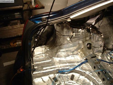 1978 Ford Bronco - Sound deadening material is being installed in the interior of a vehicle, covering the floor and rear panels.