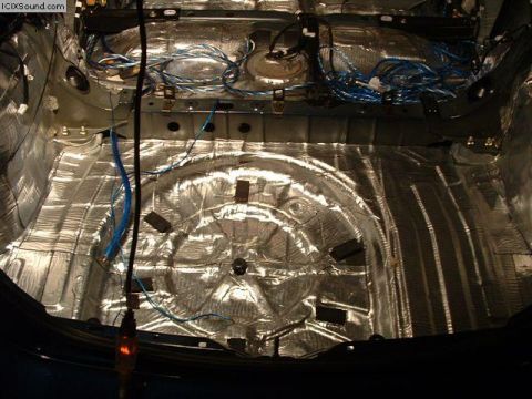 1978 Ford Bronco - The interior of a car is shown with sound deadening material and various wires installed on the floor and sides.