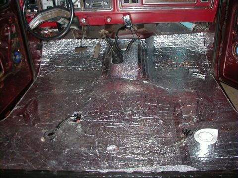 1978 Ford Bronco - Sound deadening material covers the floor of a 1978 Ford Bronco during installation.