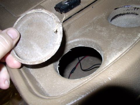 1978 Ford Bronco - Interior view of a vehicle's center console, showing a removed cup holder cover and exposed wiring.