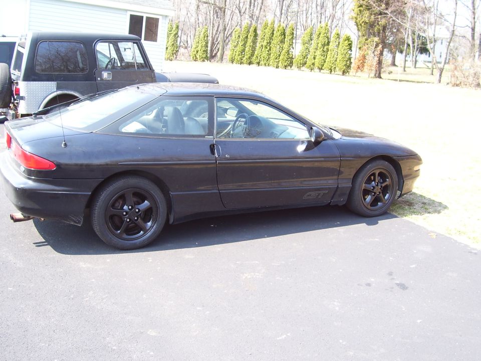 1993 Ford Probe GT parked next to a Jeep