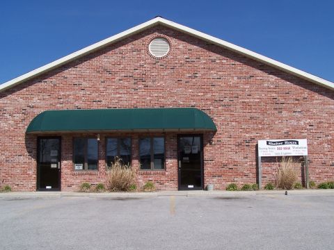 1995 Ford Probe - Exterior view of a brick building with a green awning and signage indicating shelter hours.