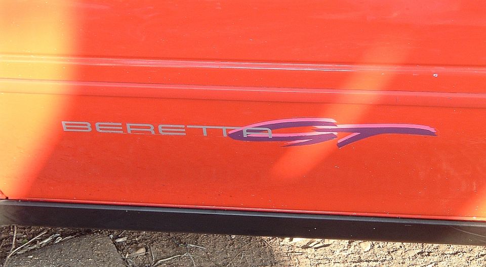 Red door with silver BERETTA lettering and purple GT graphic decal
