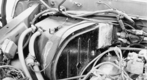 1978 Ford Bronco - A detailed view of engine components, including hoses and wiring, in a black and white photograph.