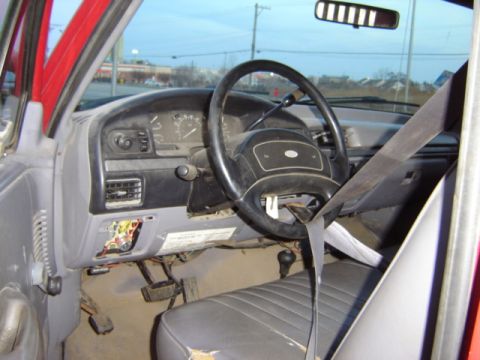 1992 Ford Bronco - Interior view of a 1992 Ford Bronco, highlighting the dashboard and worn driver's seat.