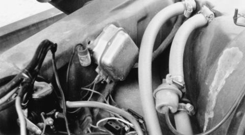 1978 Ford Bronco - Close-up view of engine components, including hoses and electrical wiring, in a black and white photograph.