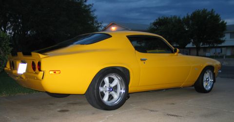 1972 Chevrolet Camaro - This yellow muscle car has a distinctive body style and a spoiler on the trunk.