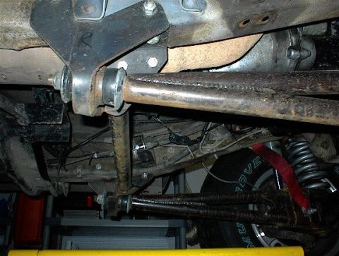 1984 Ford Bronco - Undercarriage detail with suspension parts and a tire visible. Supermotors.net logo present.
