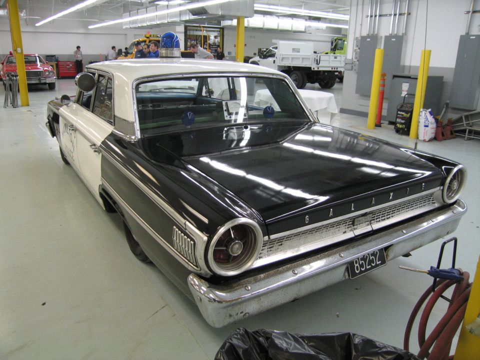 Rear quarter of a black and white 1963 Ford Galaxie with round taillights