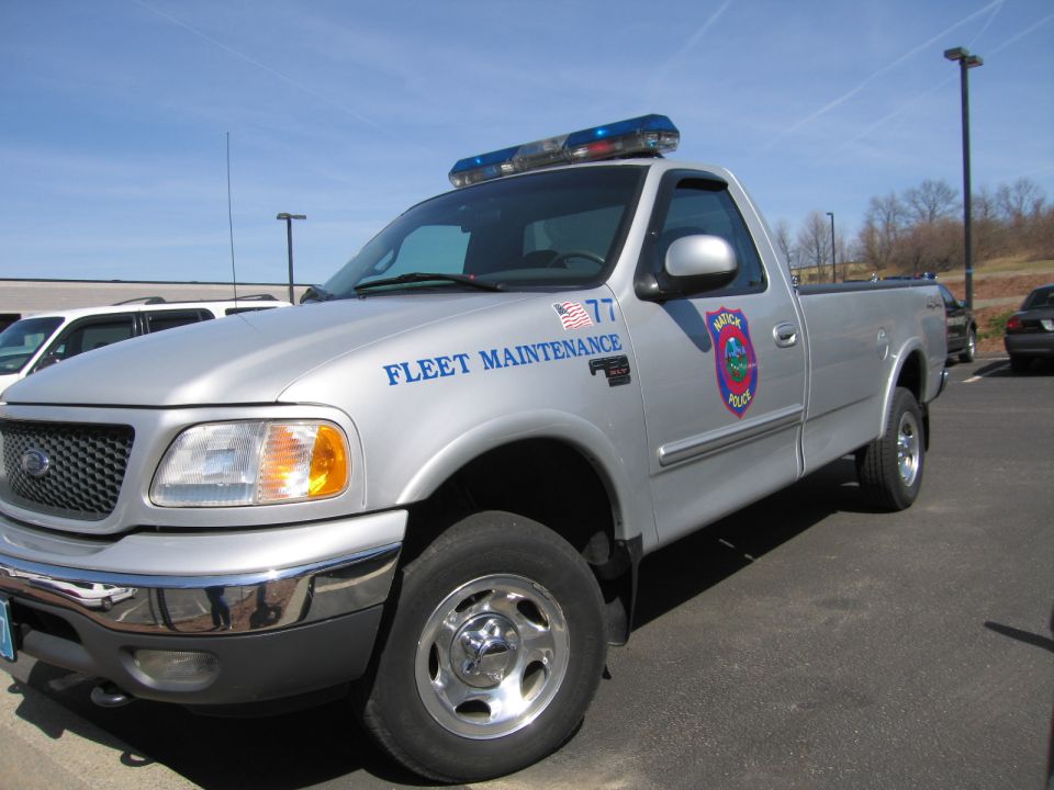 Silver Ford F-150 pickup lettered FLEET MAINTENANCE with police light bar