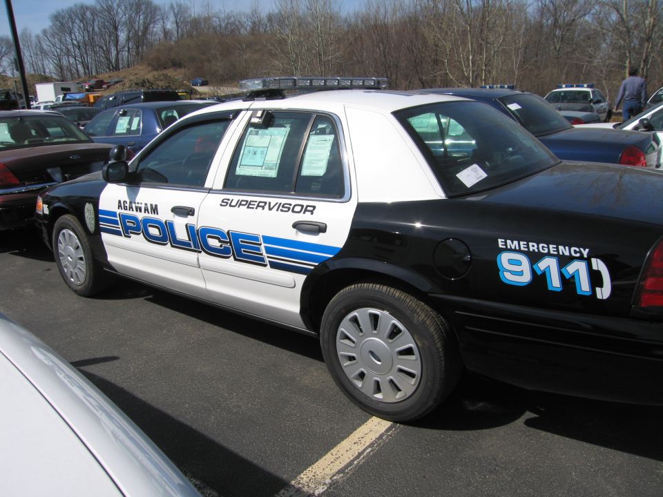 Black and white Agawam Police Ford sedan, driver-side profile view