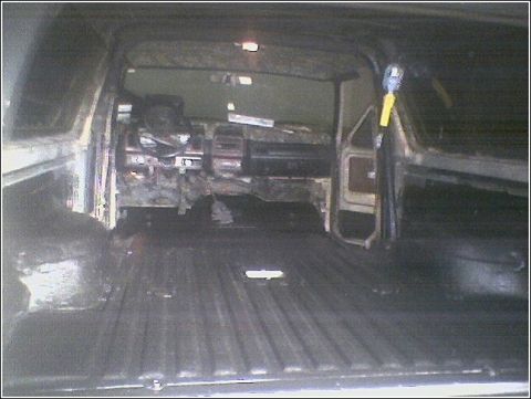 1981 Ford Bronco - The interior of a vehicle shows significant damage and disarray, with the dashboard appearing dismantled.