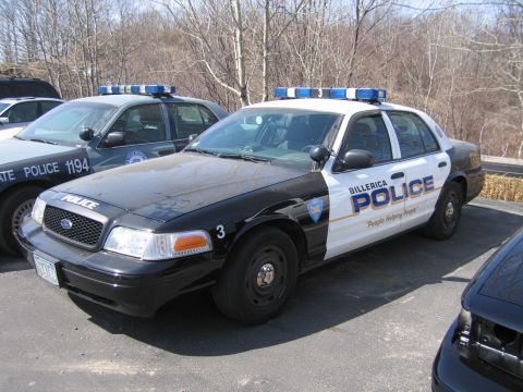 1991 Ford LTD Crown Victoria - black-and-white Billerica Police Ford sedan numbered 3 with blue light bar, parked beside other marked cruisers.