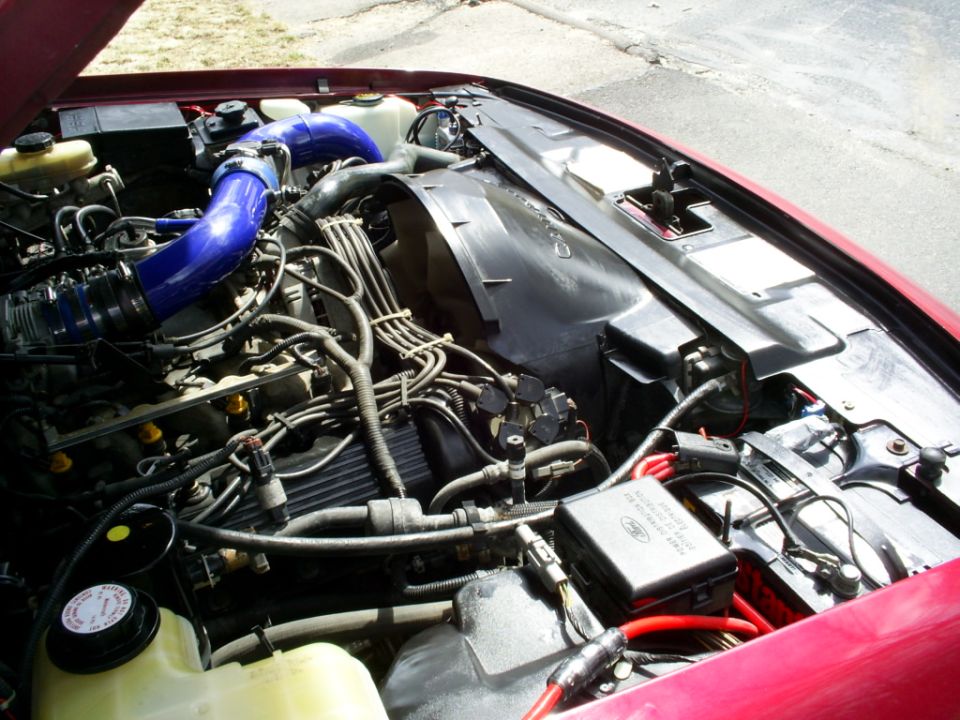 1995 Ford Crown Victoria engine bay with blue intake piping and visible wiring