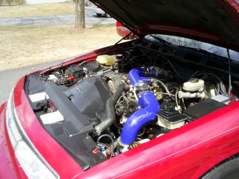 1995 Ford Crown Victoria - Engine bay of a 1995 Ford Crown Victoria, custom blue turbo piping and modified intake system.