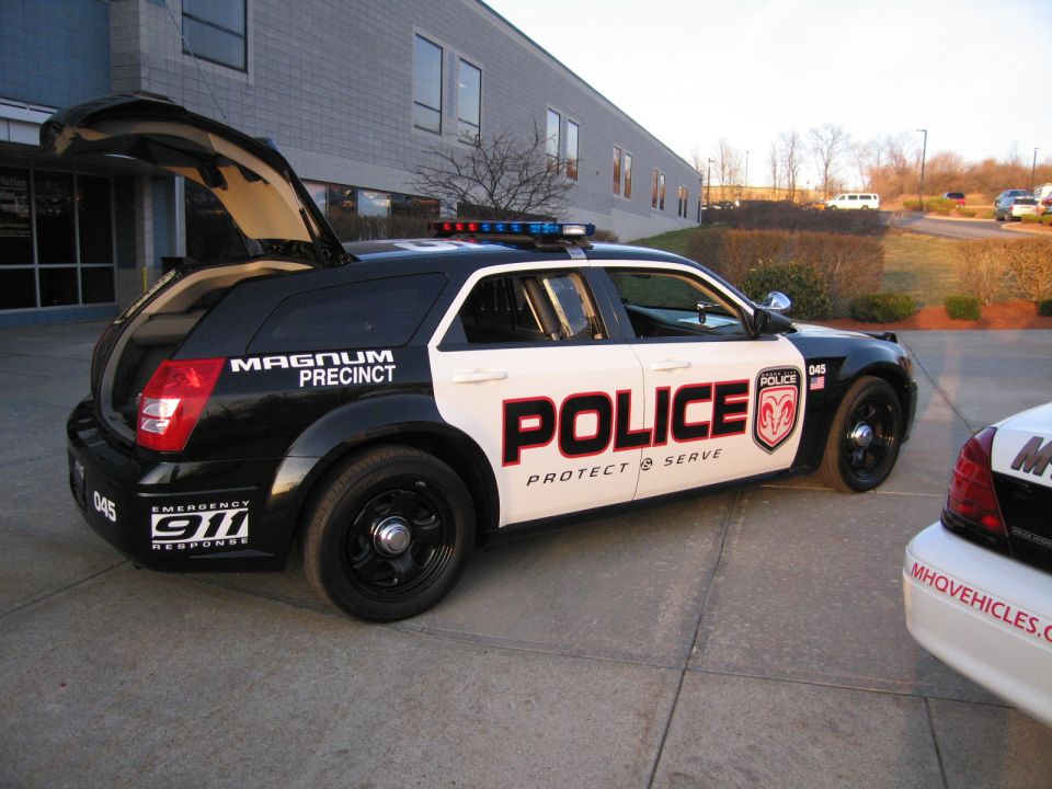 Side view of black and white POLICE Dodge Magnum wagon with light bar