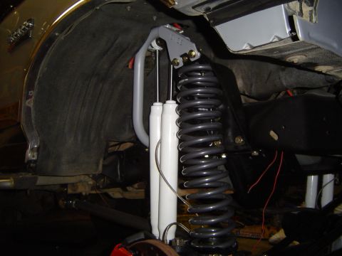 1989 Ford Bronco - Undercarriage view shows new shocks and a large coil spring installed.