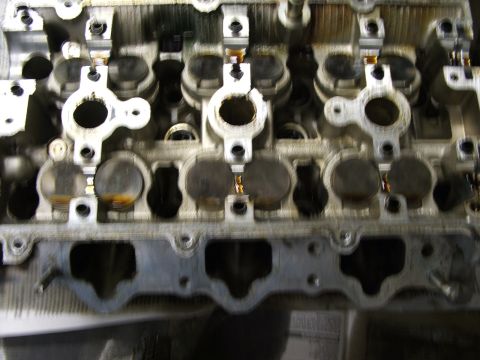 1996 Ford Probe - Close-up view of an engine's cylinder head, revealing internal components and potential wear.