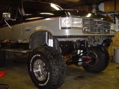 1989 Ford Bronco - Front view of a 1989 Ford Bronco showing its lifted suspension and large tires.
