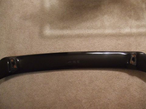 1995 Ford Probe - A black car spoiler is shown with visible mounting hardware and some faint text on its surface.