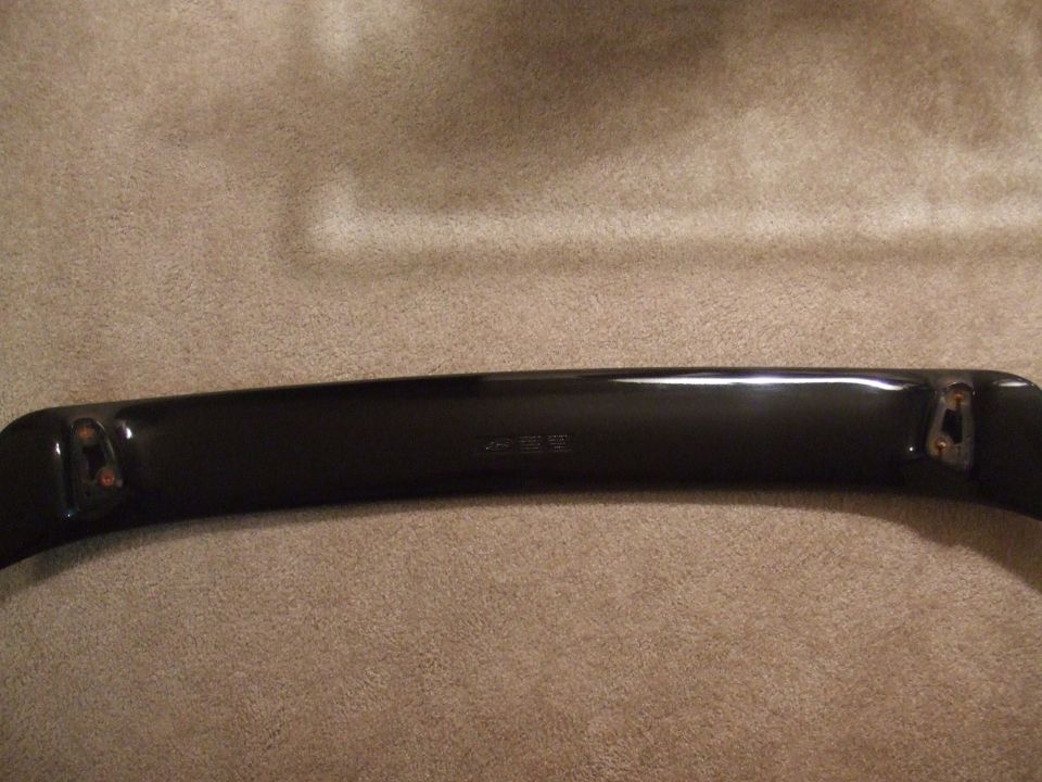 black car spoiler with mounting brackets visible