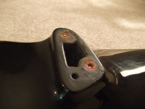 1995 Ford Probe - Close-up of a black car part showing a mounting bracket with rust and a Supermotors watermark.
