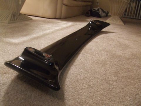 1995 Ford Probe - A black car spoiler is shown on a carpeted floor indoors.