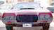 1979 Ford Ranchero - Front view of a pink car with a dark grille and visible headlights.