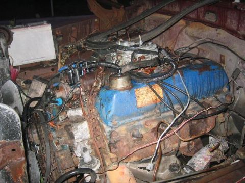 1986 Ford Bronco - Engine bay detail with a blue engine block and associated wiring and hoses.